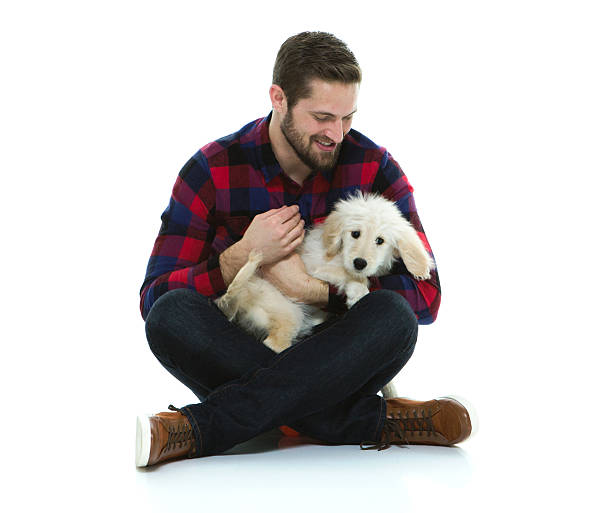 istock Smiling casual man cuddling with his dog 528735556