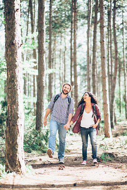 istock Cheerful young couple walking through the forest 528736912
