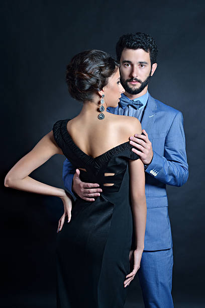 istock Beautiful lady in dress with guy in suit 528737280