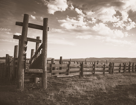An old cattle loading pen in Arizona on the San Carlos Apache Tribal reservation.  Sepia treatment brings out the soft look of the sun faded look.  This shot has a great Old West feel to it.