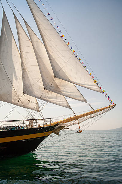 istock Old ship with white sales, sailing in the sea 528739033