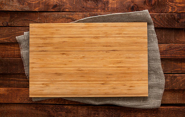 istock Cutting board on brown wooden table, top view 528739728