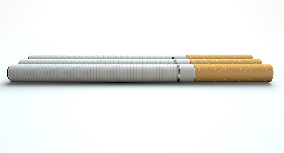 A concept image showing a close up of three regular electronic cigarettes with a glowing tips in red yellow and green lights on an isolated white studio background
