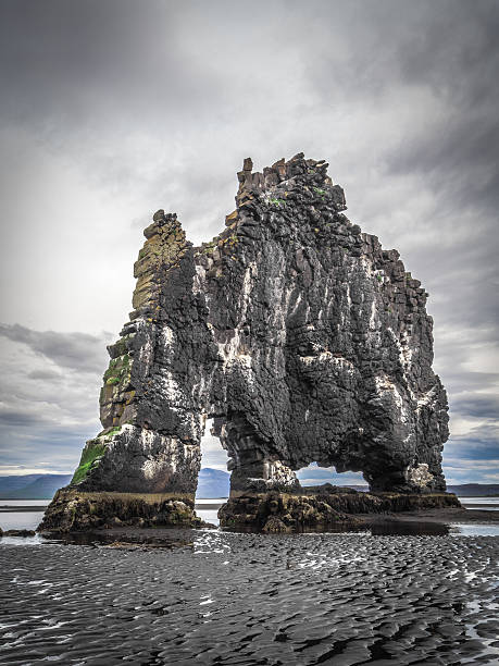 istock Single basalt rock (stack) in Iceland's fjord 528740199