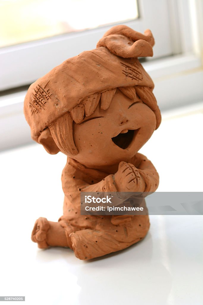 Thai boy sculpture paying respect, thai call "sawasdee" Ordinary, Thai people use the word "Sawasdee khrap/kha" , meaning in Thai "Hello" for greeting each other. It is used by Thai people for saying greeting when meet everyone, everywhere and every time. Asia Stock Photo