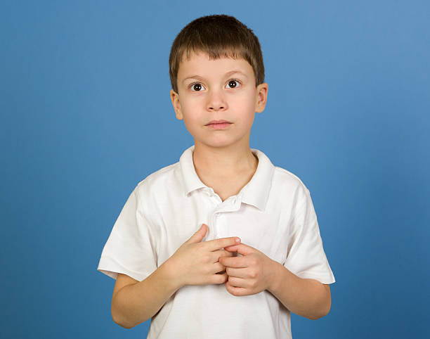 istock boy portrait in white shirt on blue 528740893