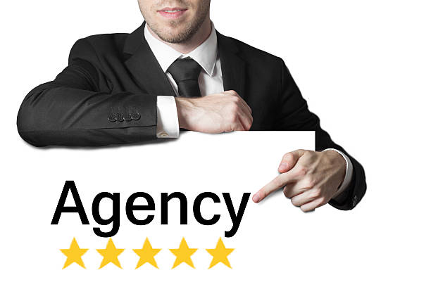 istock businessman pointing on sign agency isolated 528740941