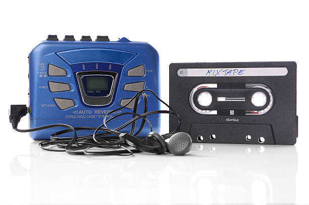 music cassette and walkman old-fashioned music cassette and walkman player with earphones personal stereo stock pictures, royalty-free photos & images