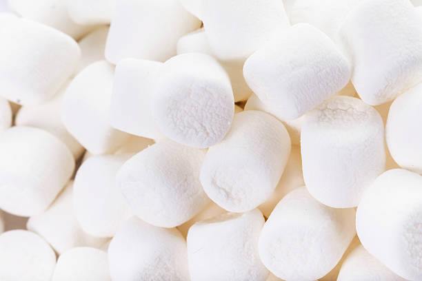 istock Delicious mini White Fluffy Round Marshmallows on white backgr 528741337