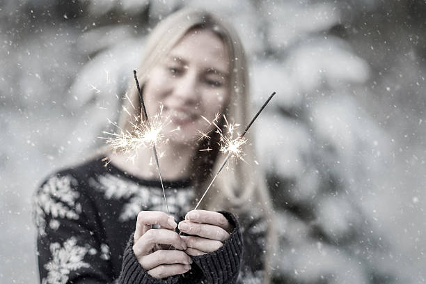 istock woman with sparkler at winter. 528741922