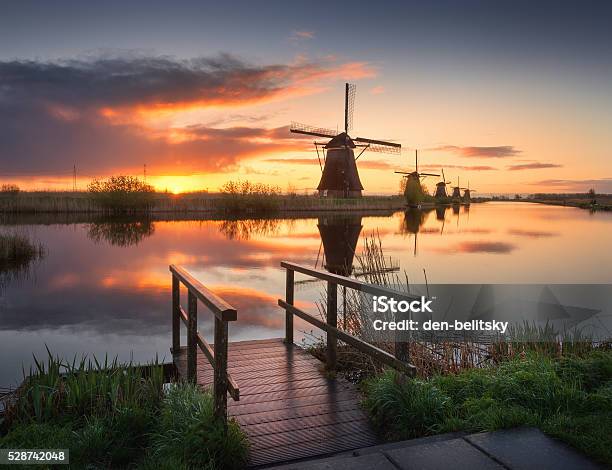 Landscape With Traditional Dutch Windmills At Colorful Sunrise Beautiful Sky Stock Photo - Download Image Now