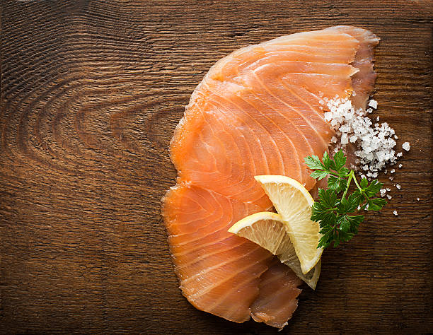 Salmon Slice of smoked salmon with sea salt and parsley smoked salmon stock pictures, royalty-free photos & images