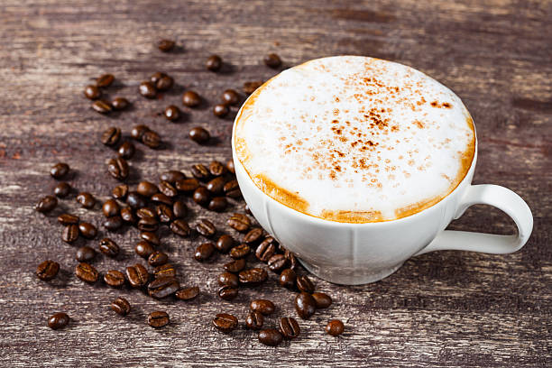 istock Cup of coffee and roasted bean on old wooden table 528742797