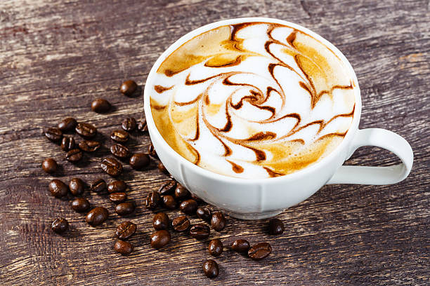 istock Cup of coffee and roasted bean on old wooden table 528742867