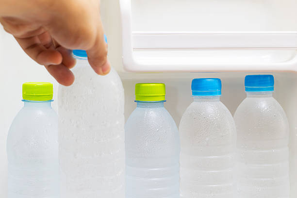 istock hand picks pure fresh cool bottles of water from refrigerator 528743013
