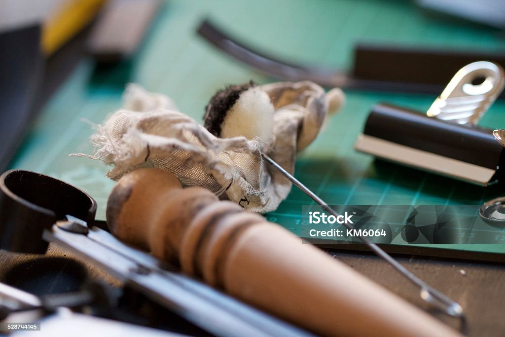 Craft Bench Leather working craft bench with leather trimmings and tools Accuracy Stock Photo