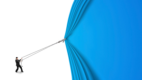 businessman pulling open blue curtain with blank behind isolated on white background