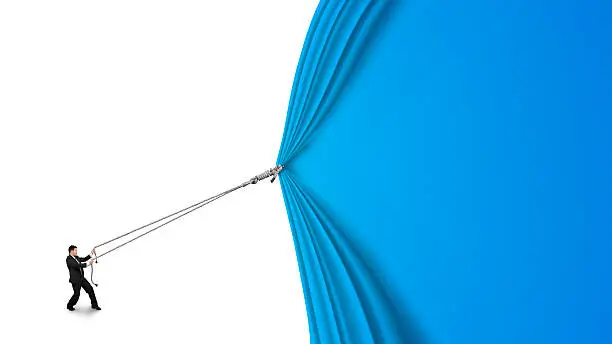 Photo of businessman pulling open blue curtain with blank white backgroun
