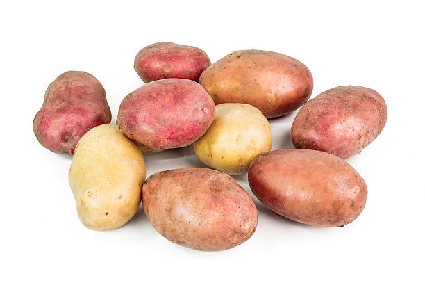 istock Red, pink and white Potato tubers on white background 528745385