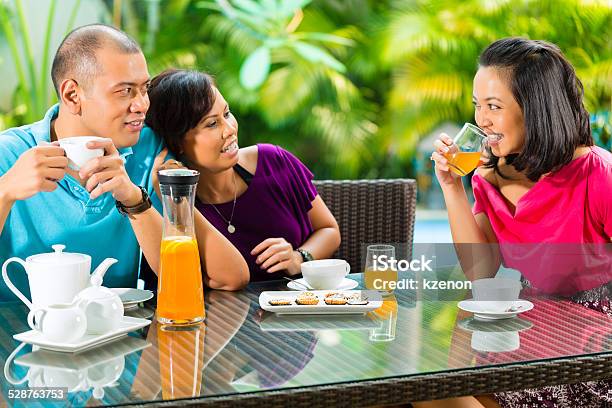 Asian Friends Having Coffee On Home Porch Stock Photo - Download Image Now - Adult, Adults Only, Afternoon Tea