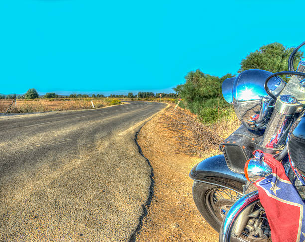 istock classic motorcycle on the edge of a winding road 528764953