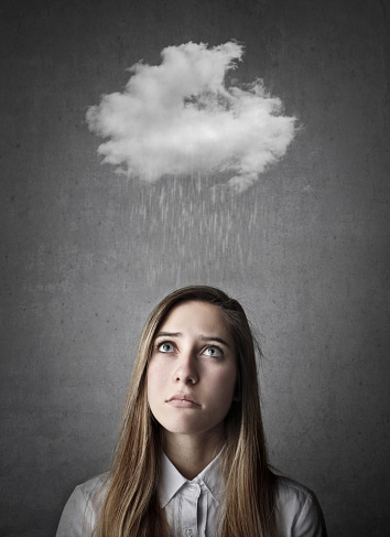 A woman has got a cloud and rain over her head