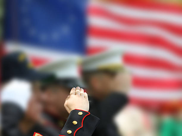 Soldiers Saluting Soldiers and veteran salute the American flag. air force salute stock pictures, royalty-free photos & images