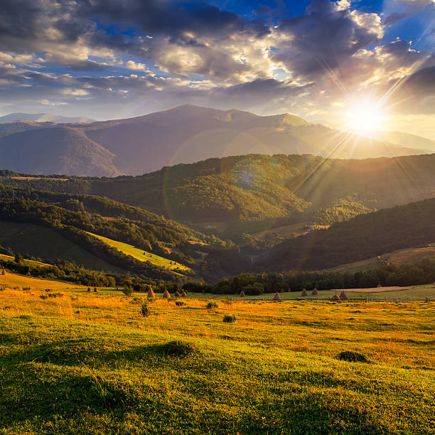 istock field on hillside near village at sunset 528767151