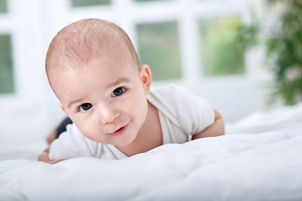 istock Smiling happy beautiful baby lying on bed 528768131