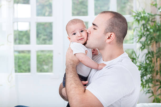 istock Father hugging and kissing his little son 528769095
