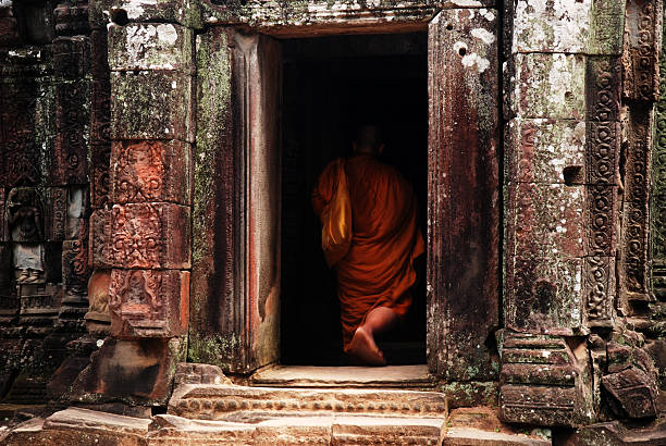 istock Monk enters Bayon Temple at Angkor Thom, Cambodia 528777473