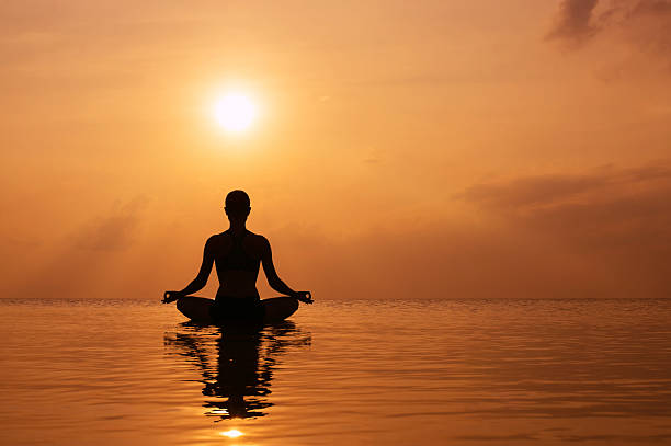 istock Silhouette young woman practicing yoga 528780031