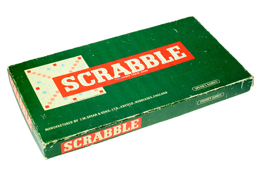 London, England - July 18, 2013: Scrabble Boardgame, Scrabble is a word game involving two to four players and the idea is to create words using tiles which have a printed letter of the alphabet on each, When a players tiles have all been used up they are the winner.