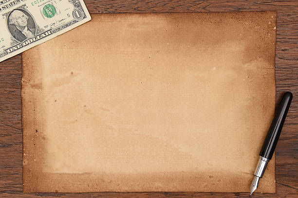 istock one dollar and pen with old papers for background. 528796187