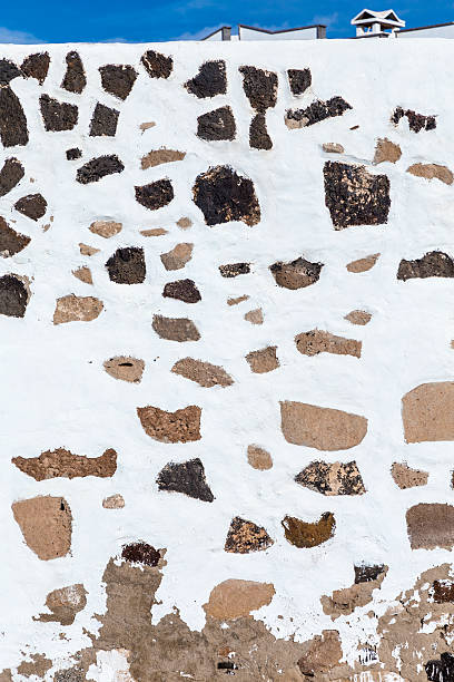 istock house wall in Lanzarote with typical white paint and stones 528811373