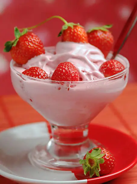 Cup of  fresh strawberry cream with spoon