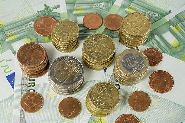 istock stack of Euro coins to banknotes 100 Euro 528815677