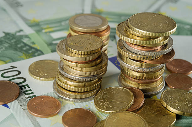 istock stack of Euro coins to banknotes 100 Euro 528825053
