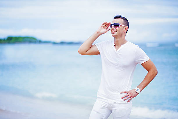 istock Man in white cloths on the beach 528828233
