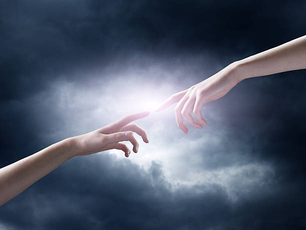 istock religion concept. finger touching the magic sky 528829203