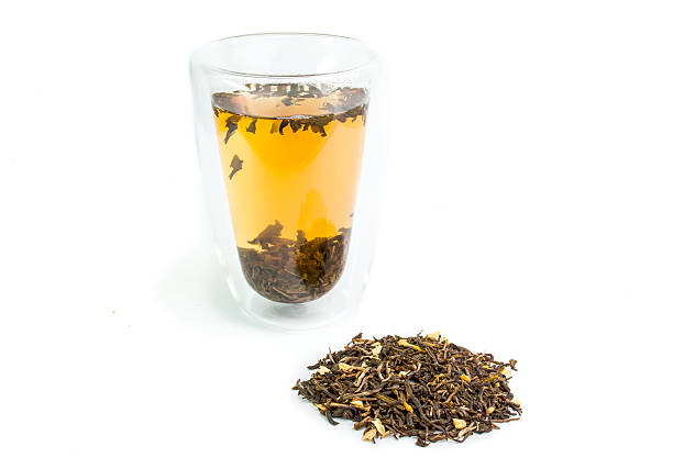 istock Green tea in a glass dry tea isolated on white 528829445