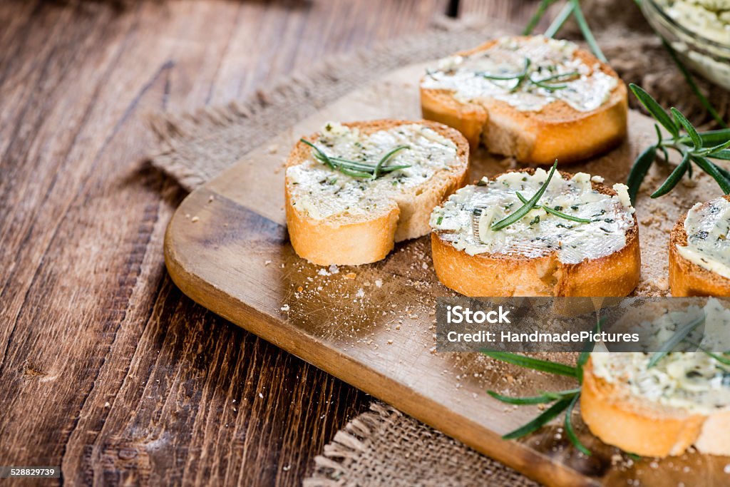 Herb Butter Baguette Herb Butter Baguette (detailed close-up shot) on wooden background Herb Butter Stock Photo