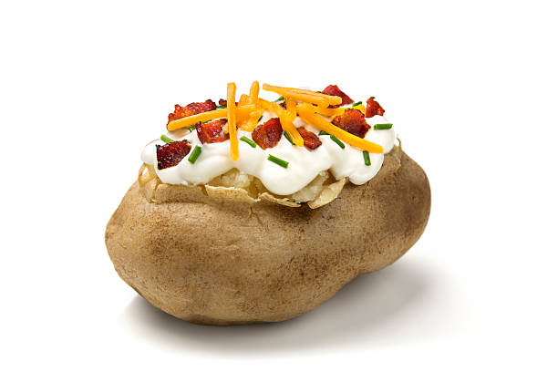 Baked Potato Baked potato with bacon, chives, and cheddar cheese on white background.  Please see my portfolio for other food and drink images. baked potato sour cream stock pictures, royalty-free photos & images
