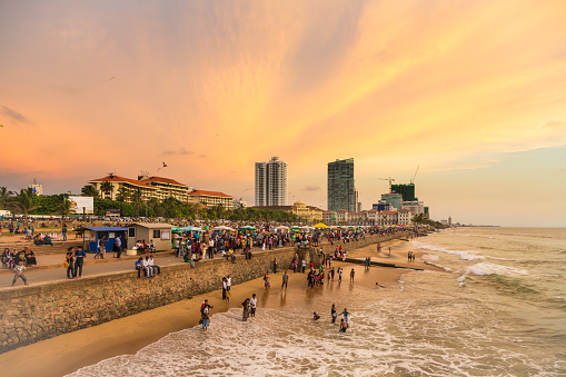 Colombo, Sri Lanka - February 16 2012: A large crowd enjoy the sunset on Galle fort road on the seafront of Colombo, the capital city of Sri Lanka