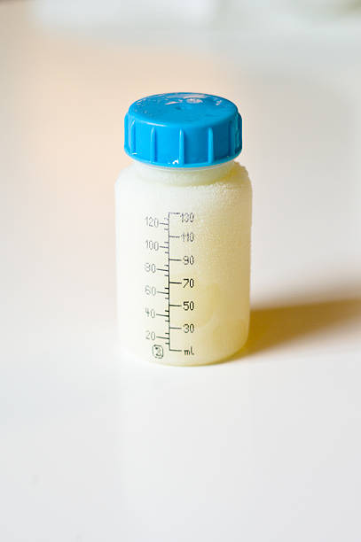 Frozen mother milk in a bottle stock photo