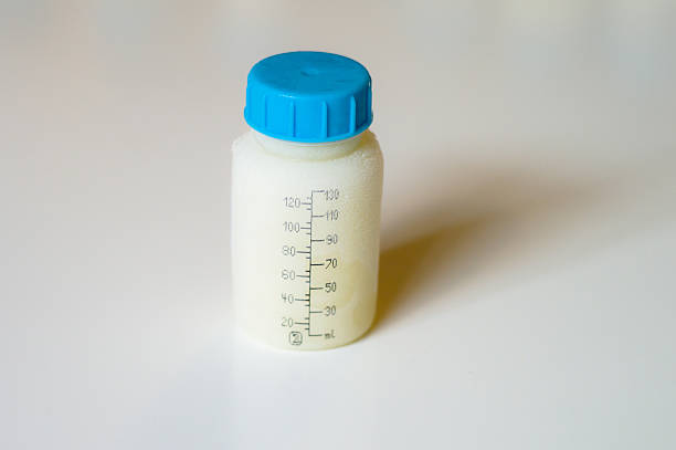 Frozen mother milk in a bottle stock photo