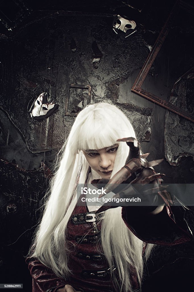 Master of nightmares Wicked horrible vampire with cursed hand posing over grunged background Adult Stock Photo