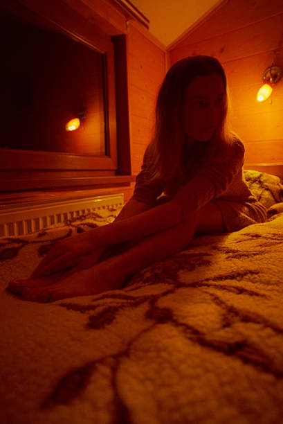 istock Young woman sitting on the bed in evening 528862945