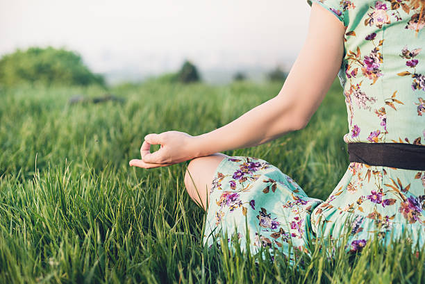 Pretty woman meditate in the park stock photo