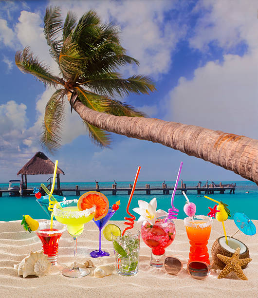 istock Colorful tropical cocktails at beach on white sand 528864987